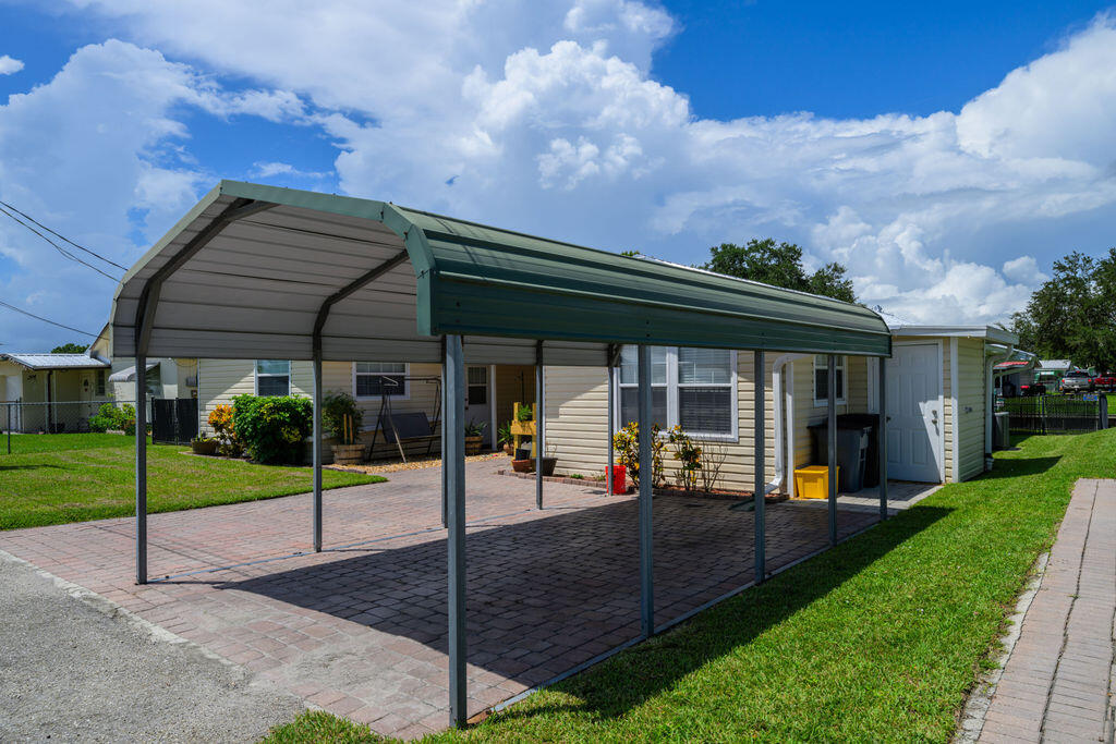 1044 4th Street Okeechobee, FL 34974 - Photo 8 of 39 a view of a house with a big yard garden and patio