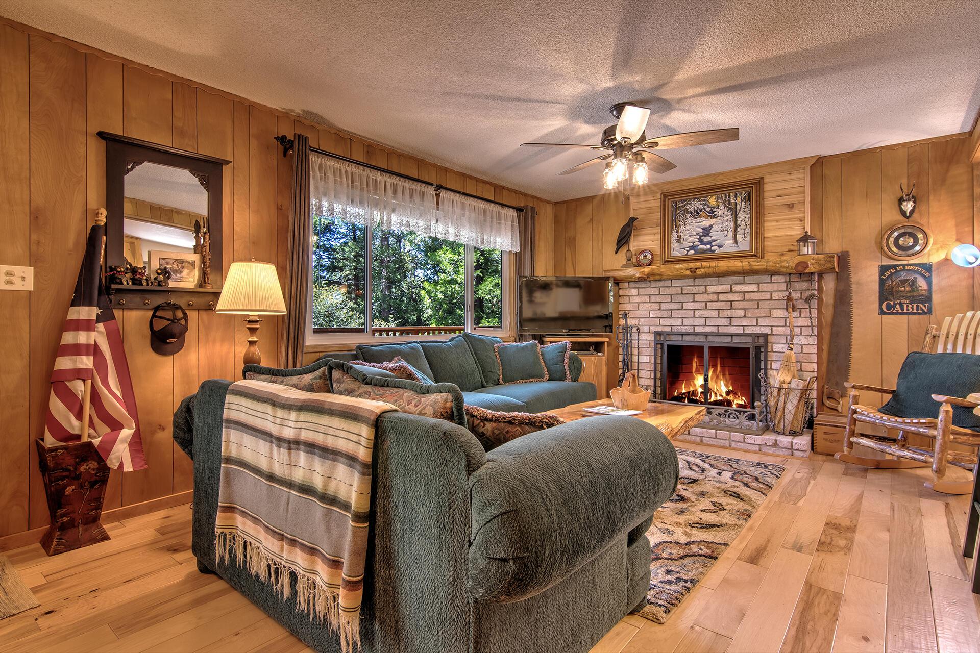 25770 Scenic Drive Idyllwild, CA 92549 - Photo 18 of 51 a living room with furniture a fireplace and a flat screen tv