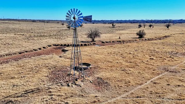 a view of a dry yard with an ocean view