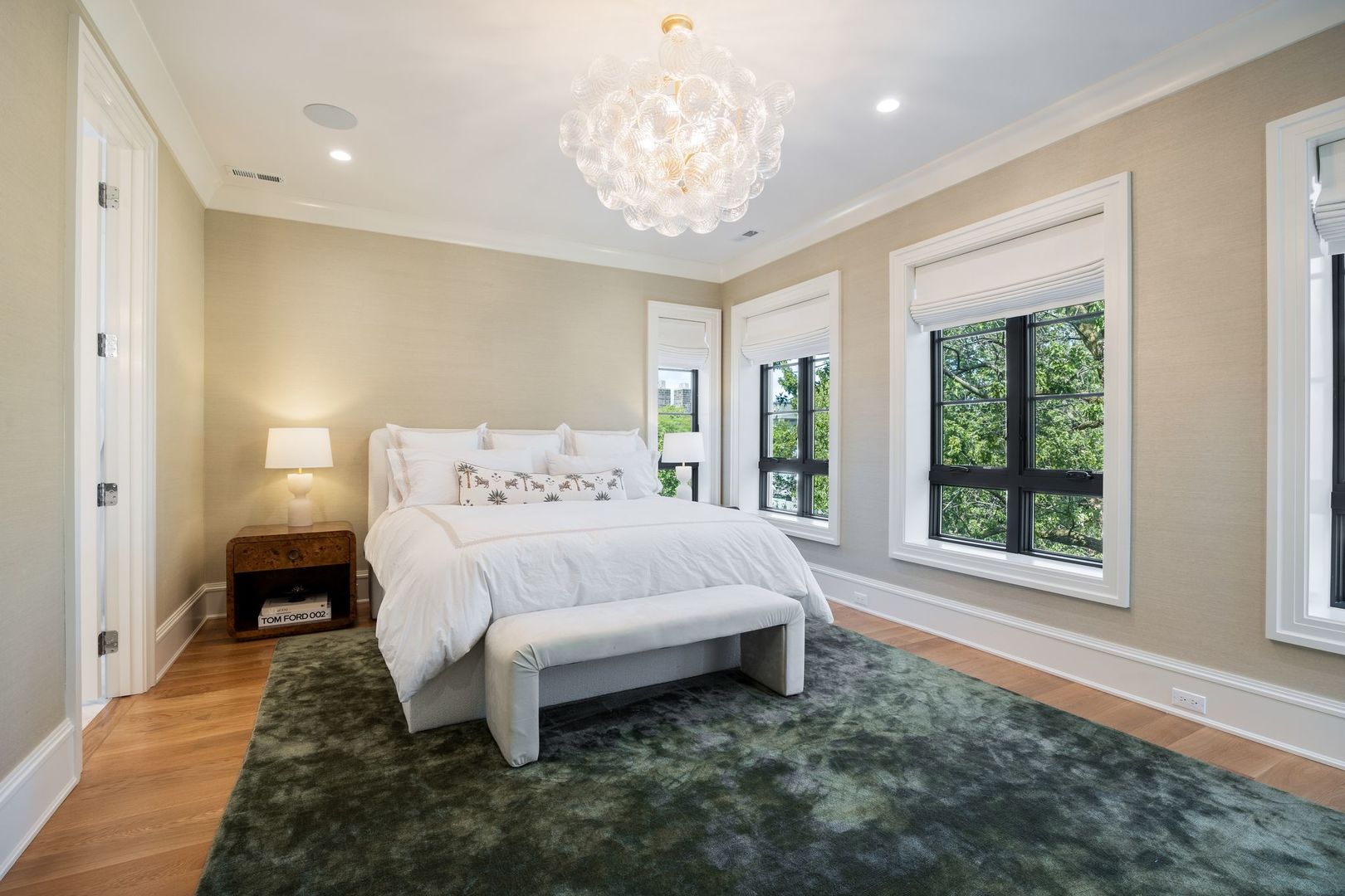 2034 North Mohawk Street, Unit 3 Chicago, IL 60614 - Photo 23 of 46 a spacious bedroom with a large bed and a chandelier