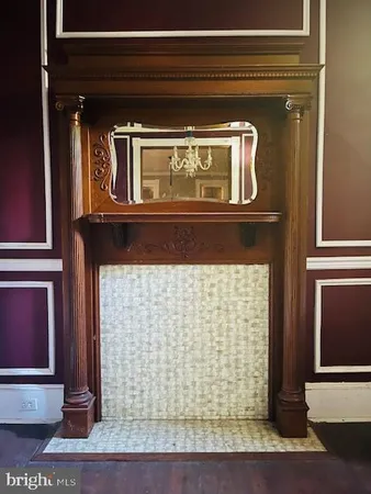 a view of empty room with fireplace and fan