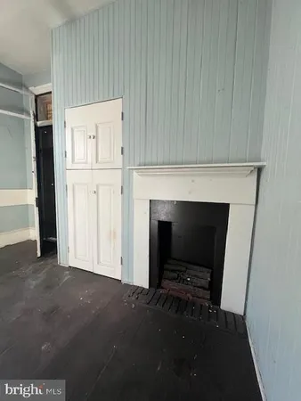 a kitchen with a stove a sink a window and cabinets