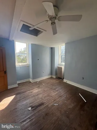 a bathroom with a bathtub and a window