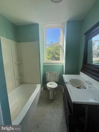 a view of a room with a window and wooden floor