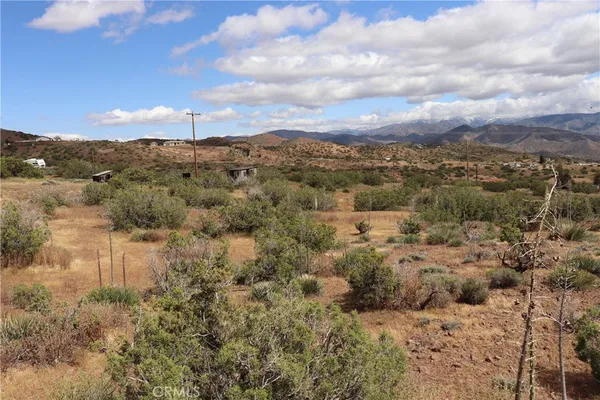 a view of a large mountain with a mountain in the background