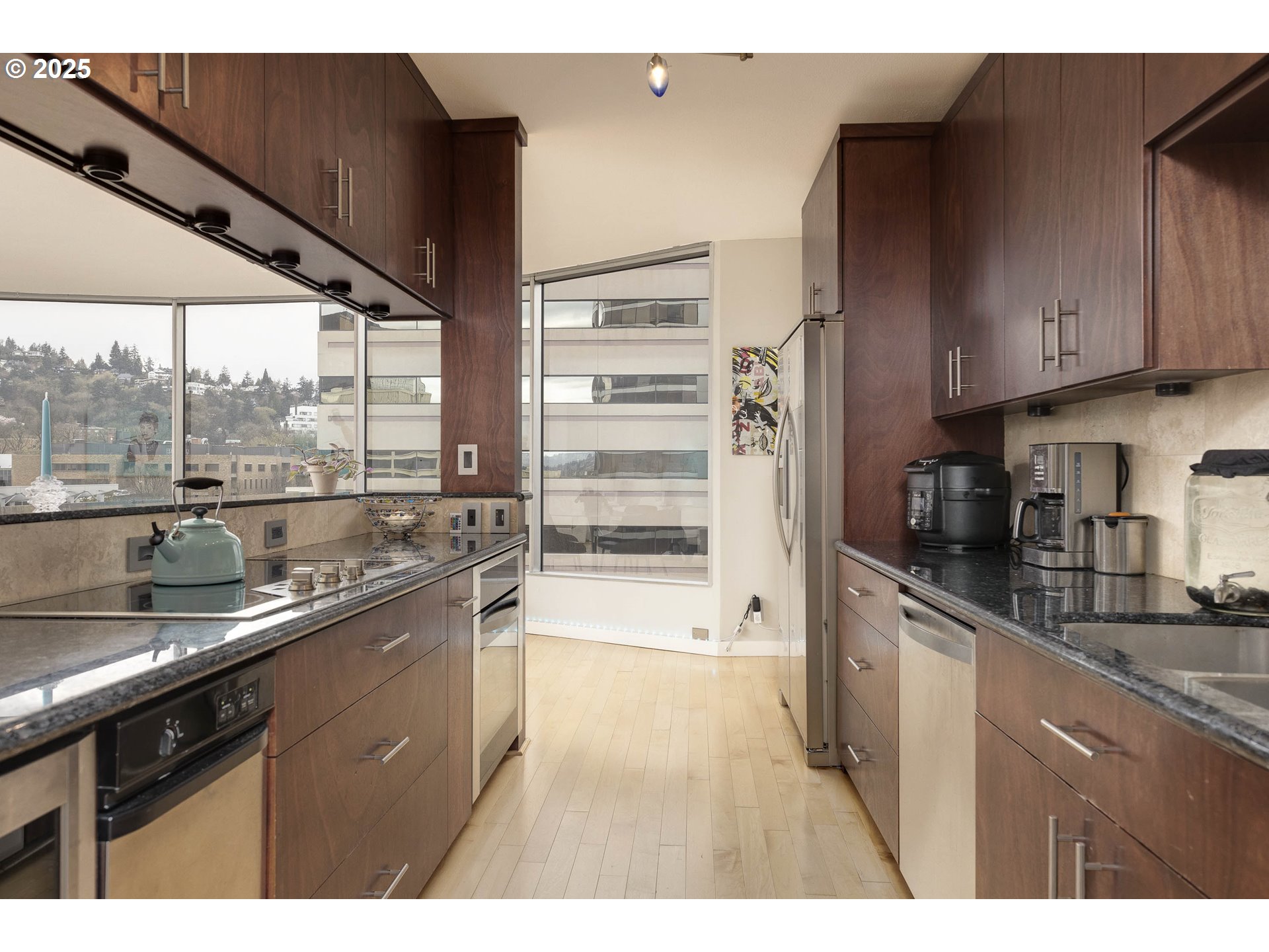 1500 Southwest 5th Avenue, Unit 906 Portland, OR 97201 - Photo 17 of 43 a kitchen with a sink and large cabinets