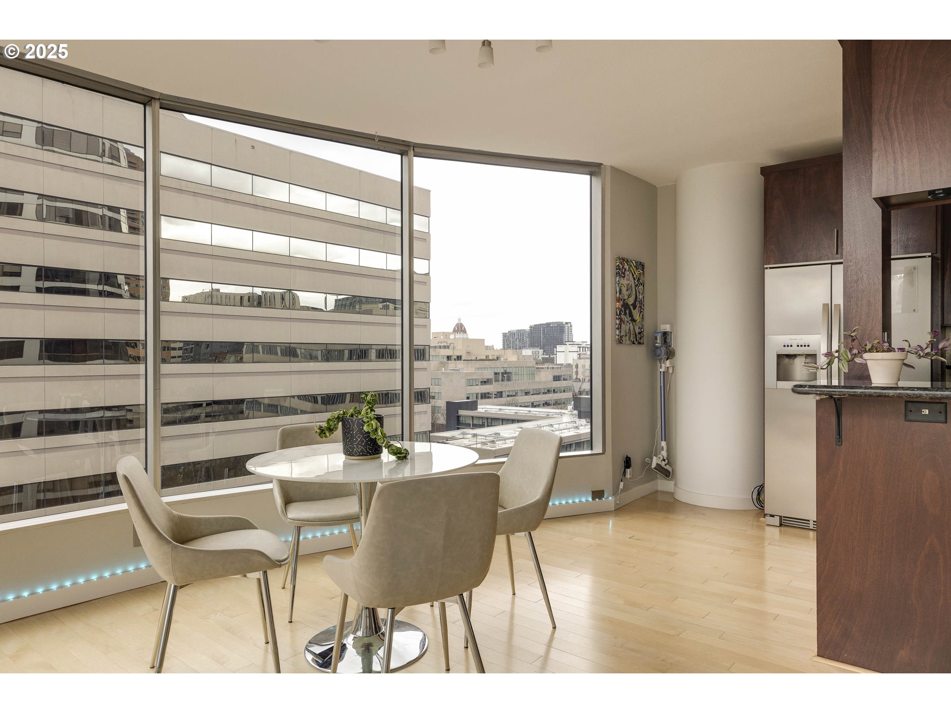 1500 Southwest 5th Avenue, Unit 906 Portland, OR 97201 - Photo 19 of 43 a dining room with furniture and wooden floor