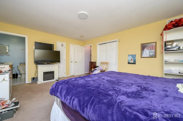a bedroom with furniture and a balcony