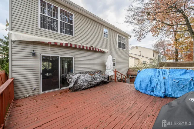 a backyard of a house with barbeque oven and table