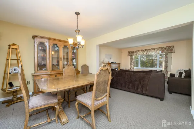 a kitchen with stainless steel appliances granite countertop a refrigerator a sink and white cabinets