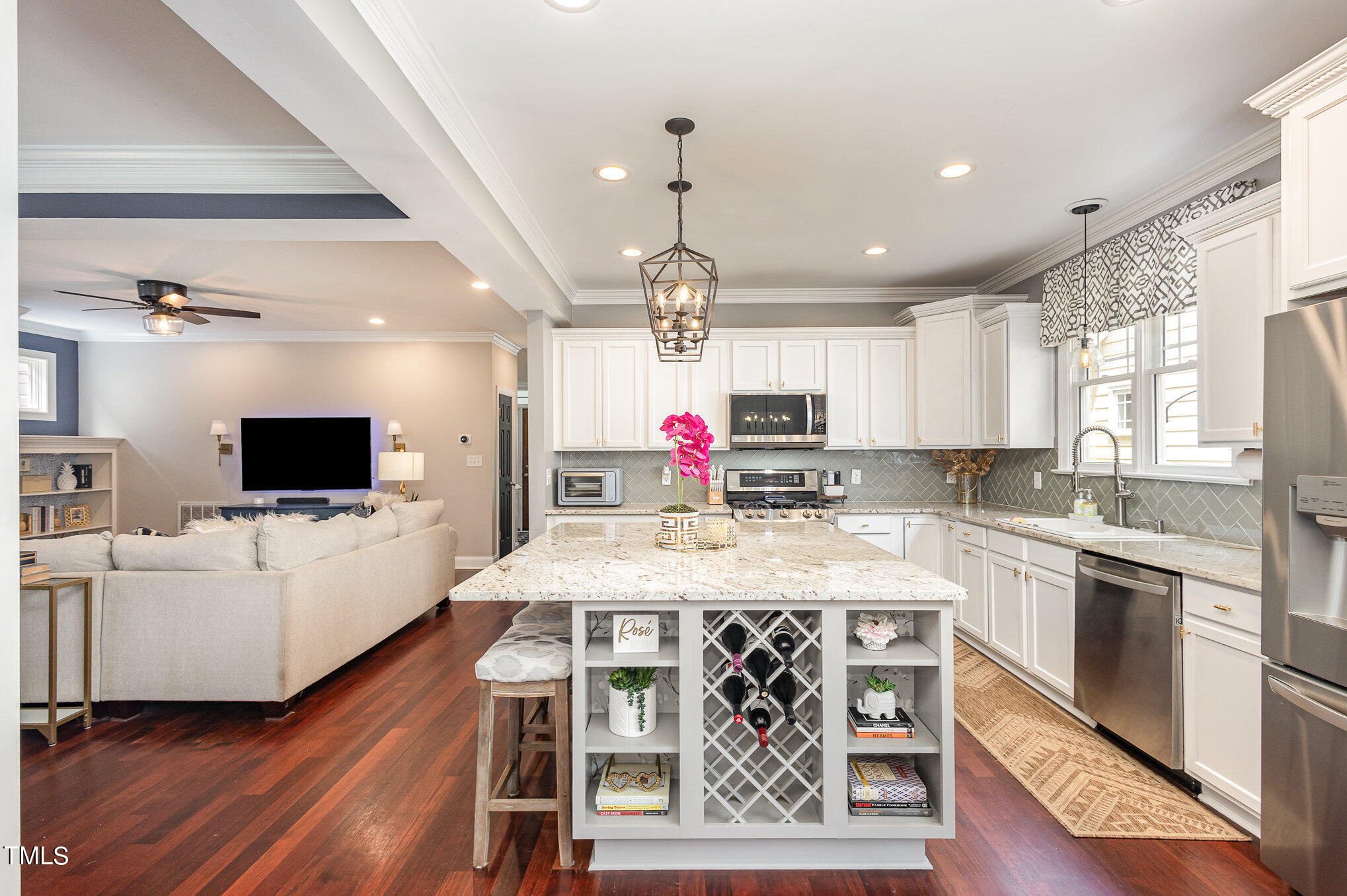 10534 Evergreen Spring Place Raleigh, NC 27614 - Photo 12 of 30 a large kitchen with kitchen island a large island in the center and stainless steel appliances