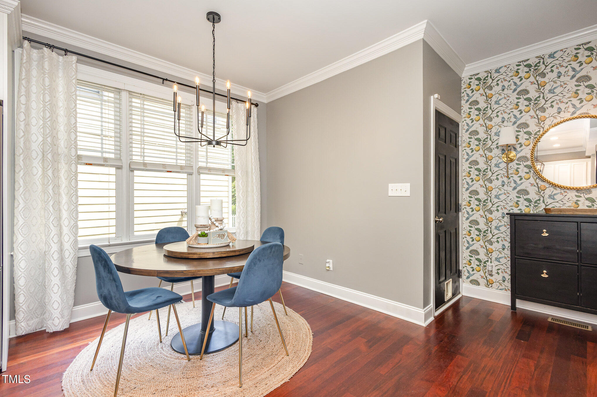 10534 Evergreen Spring Place Raleigh, NC 27614 - Photo 10 of 30 a dining room with furniture a chandelier and wooden floor