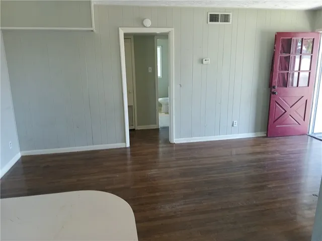 a view of hallway with wooden floor