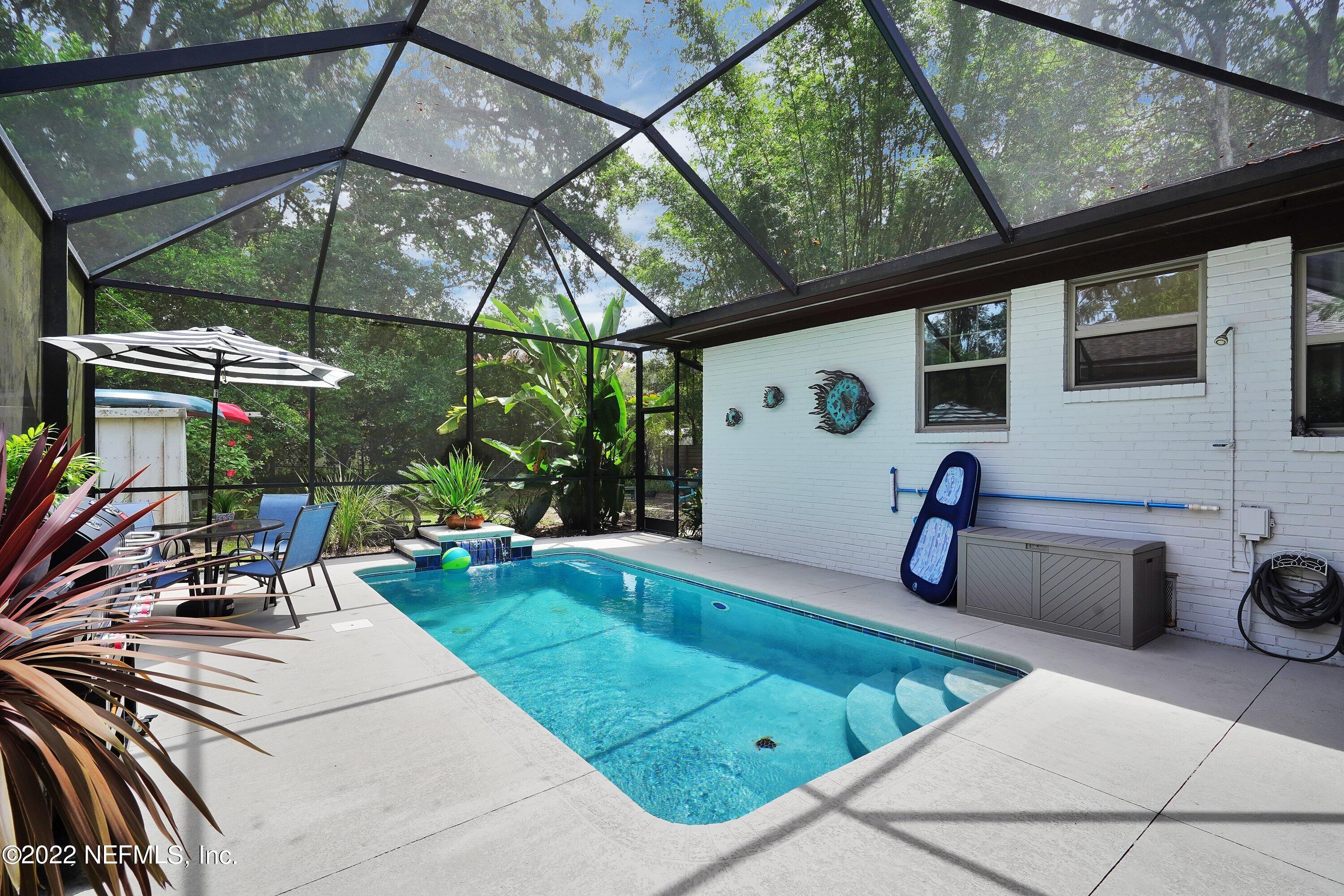 5329 Stanford Road Jacksonville, FL 32207 - Photo 22 of 28 a view of a patio with table and chairs under an umbrella