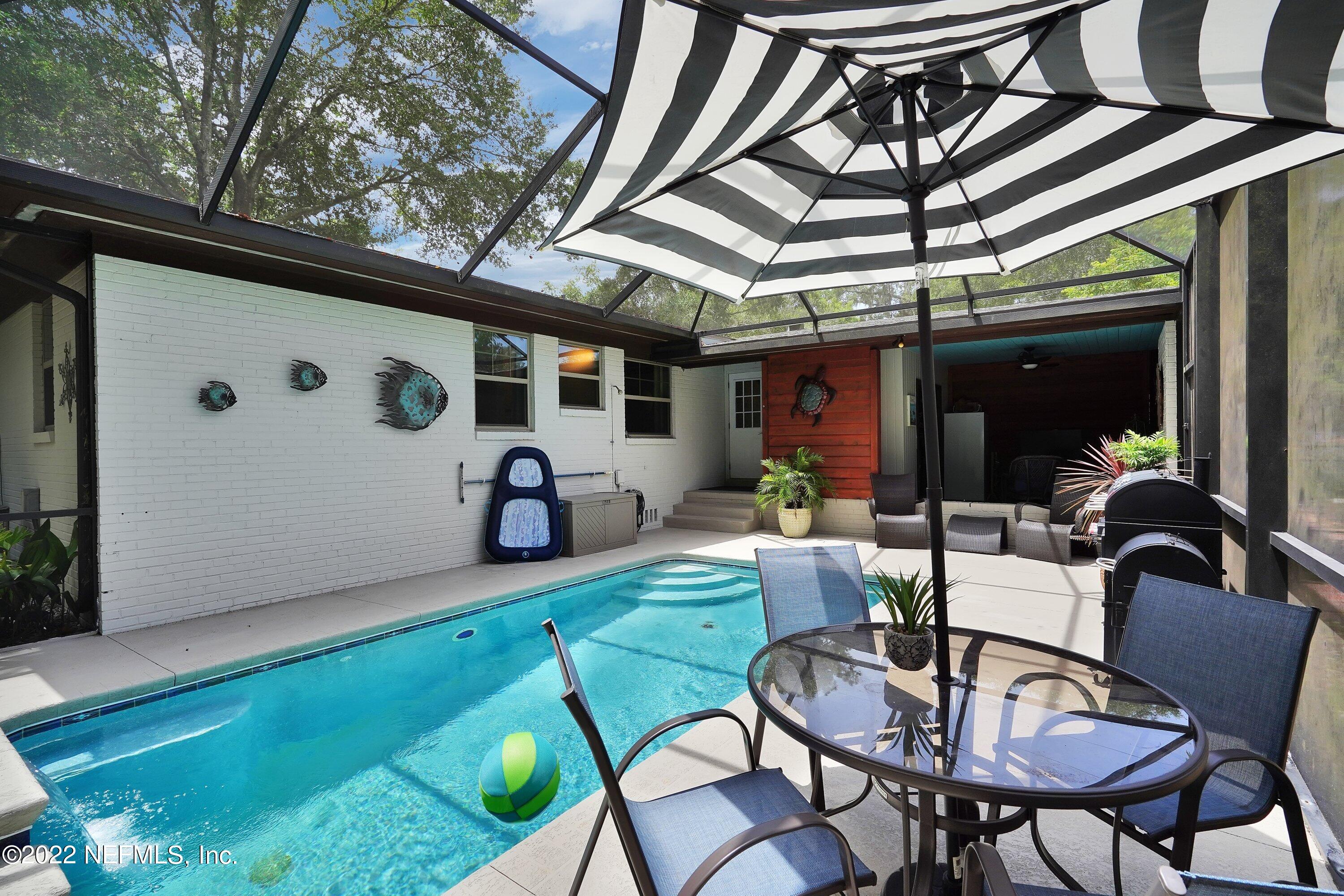 5329 Stanford Road Jacksonville, FL 32207 - Photo 23 of 28 a backyard of a house with table and chairs