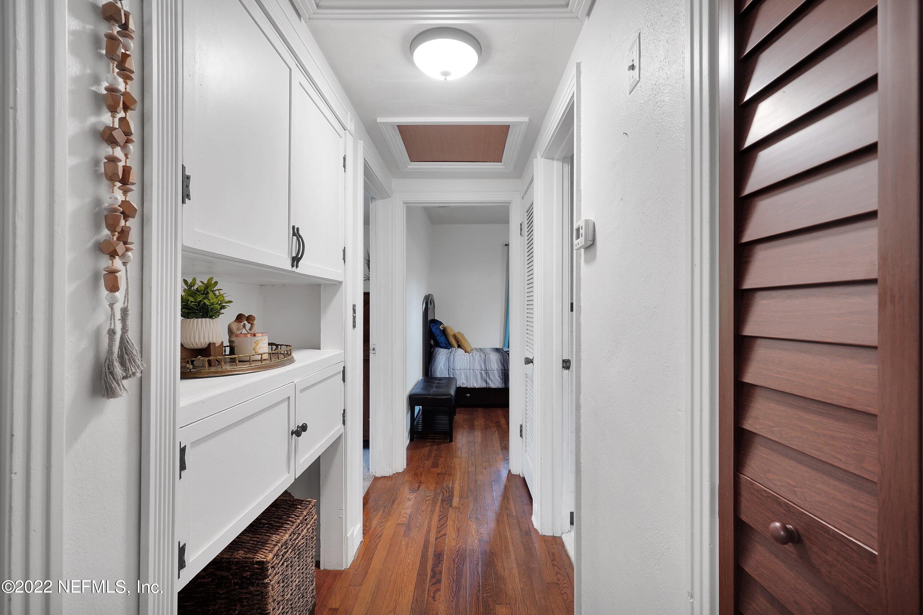 5329 Stanford Road Jacksonville, FL 32207 - Photo 10 of 28 a hallway with white cabinets and wooden floor