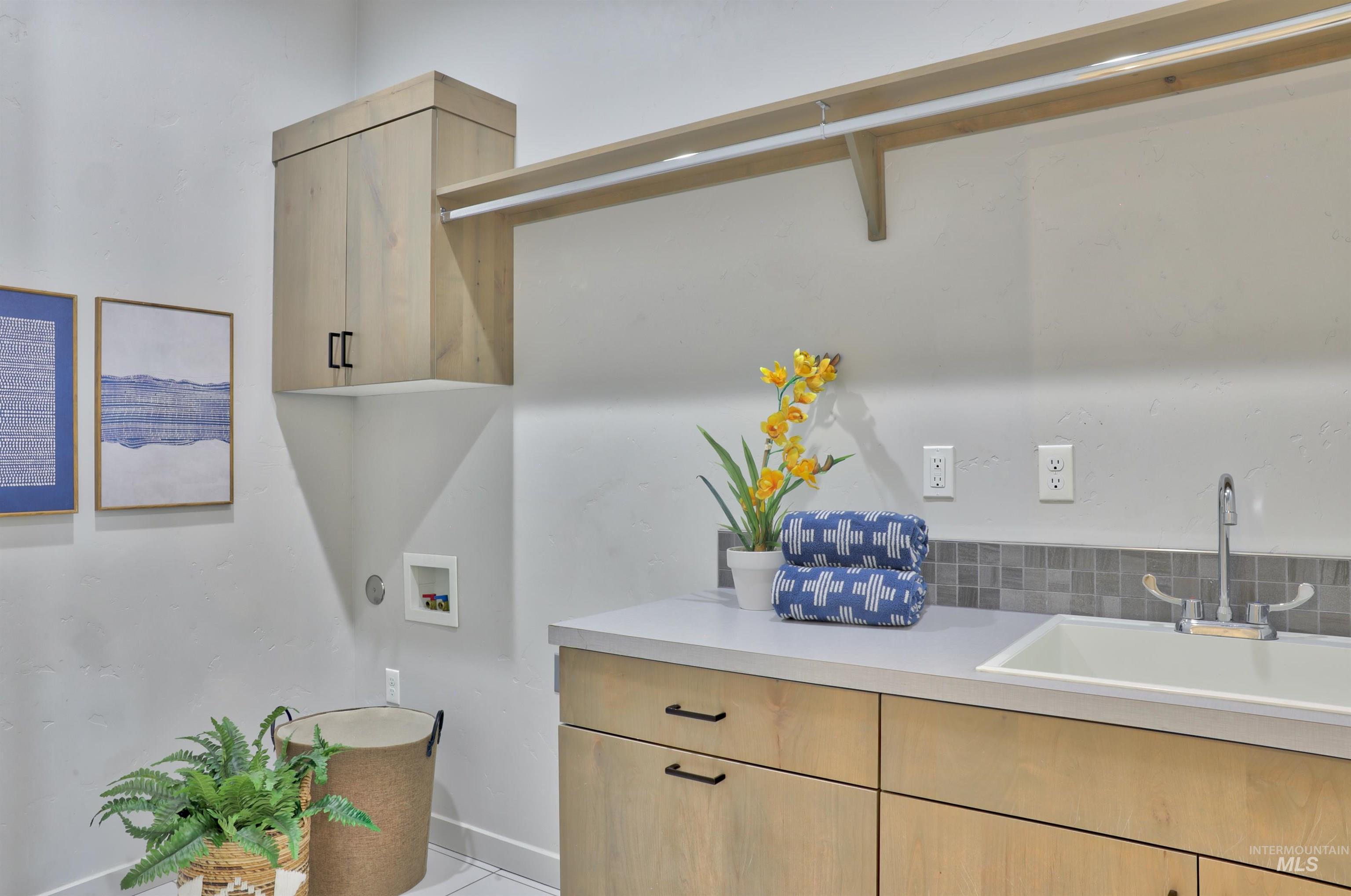 4148 East Copper Point Drive Meridian, ID 83642 - Photo 19 of 26 Laundry room with hookup for a washing machine and cabinet space
