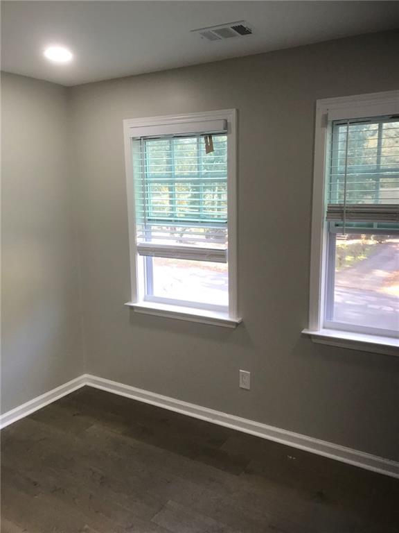 1884 Shamrock Drive Decatur, GA 30032 - Photo 1 of 1 an empty room with wooden floor and windows