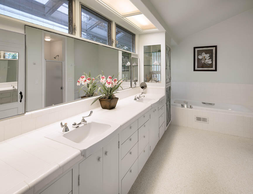 8316 Bates Road Ventura, CA 93001 - Photo 12 of 25 a bathroom with a double vanity sink a mirror and a bathtub