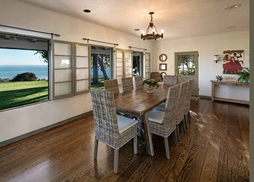 8316 Bates Road Ventura, CA 93001 - Photo 8 of 25 a dining room with wooden floor a chandelier a wooden table and chairs