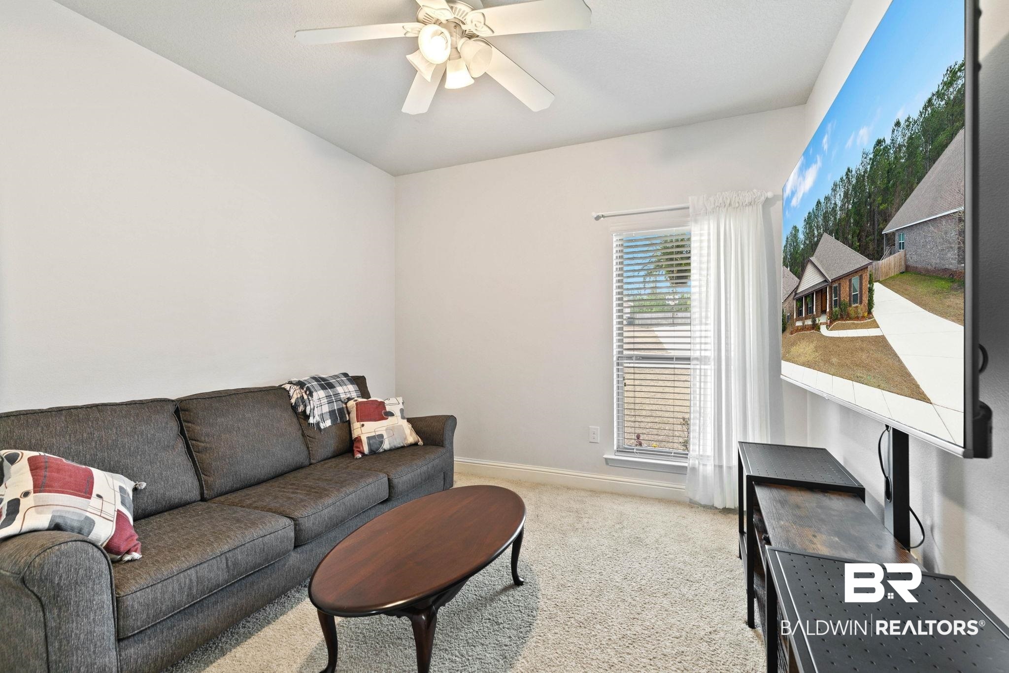 31350 Hoot Owl Road Daphne, AL 36527 - Photo 39 of 94 Living area with light carpet and a ceiling fan