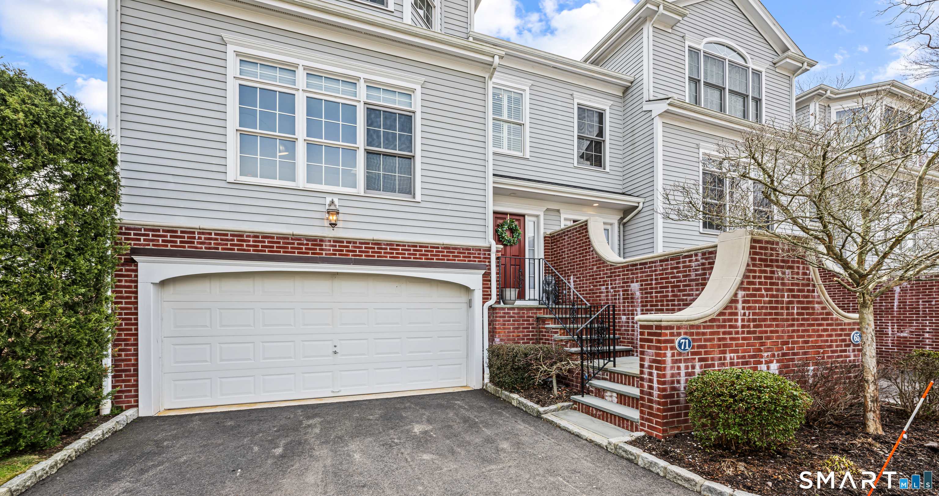 71 Aberdeen Way, Unit 71 Fairfield, CT 06890 - Photo 2 of 37 a front view of a house with garage