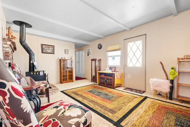 a living room with furniture rug and window