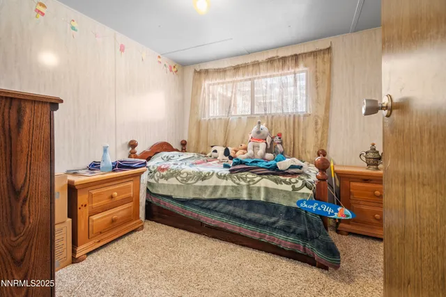 a bed room with a bed and a window