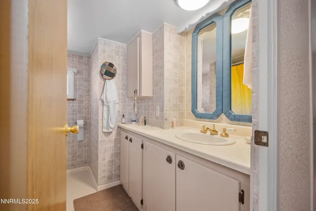 a bathroom with a double vanity sink and a mirror