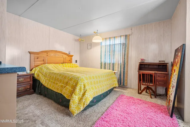 a bedroom with a bed and a desk