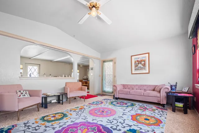 a living room with furniture and a baby crib