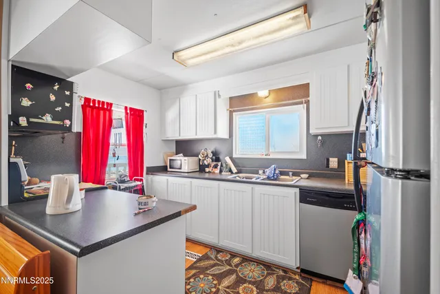 a kitchen with a sink a stove and a window