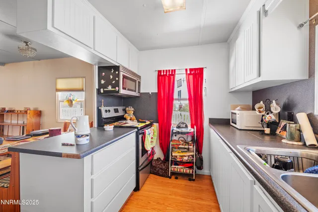 a kitchen with stainless steel appliances granite countertop a sink stove and cabinets