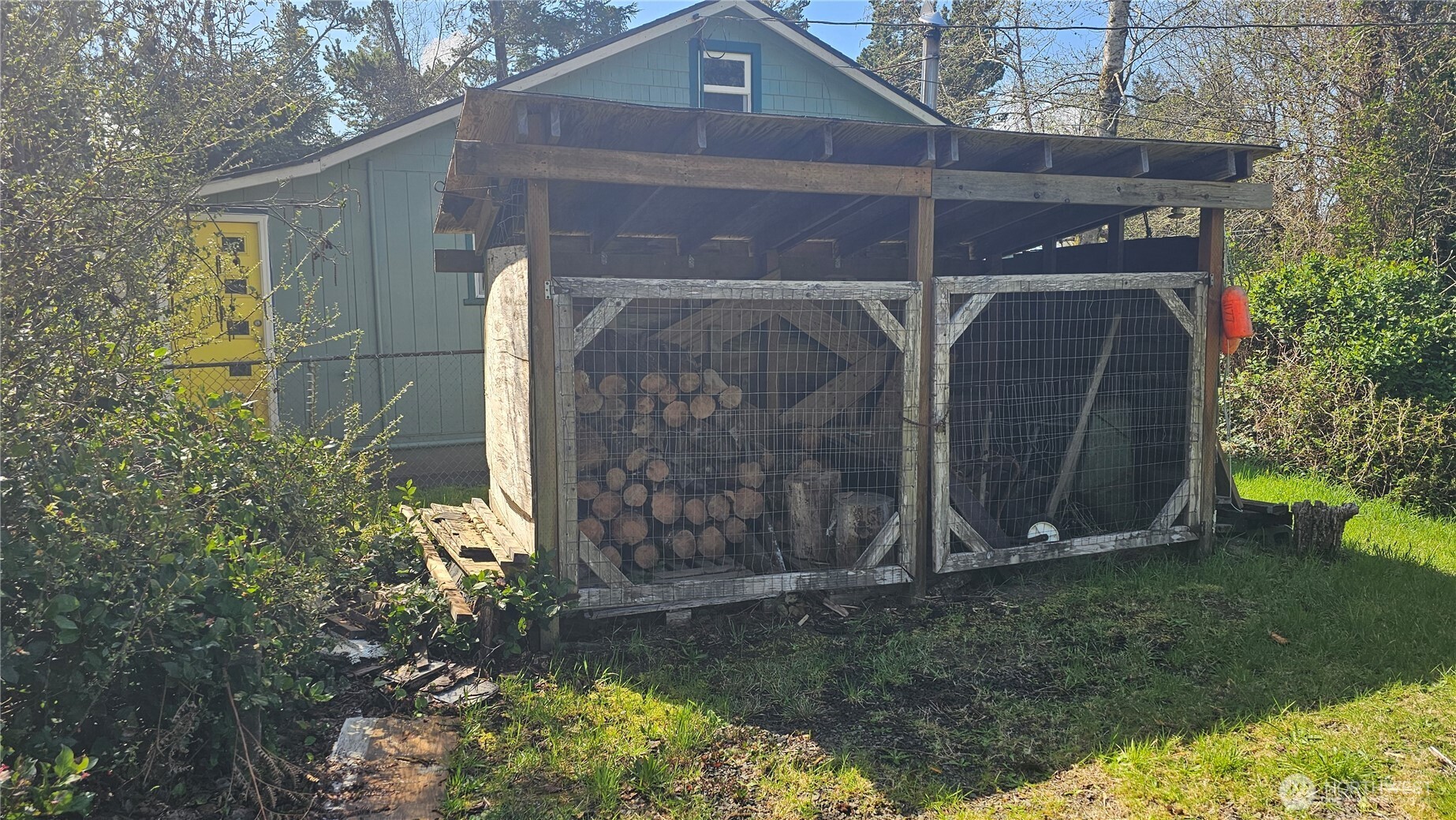 24402 P Street Ocean Park, WA 98640 - Photo 14 of 40 a view of a small house with a small yard and large trees