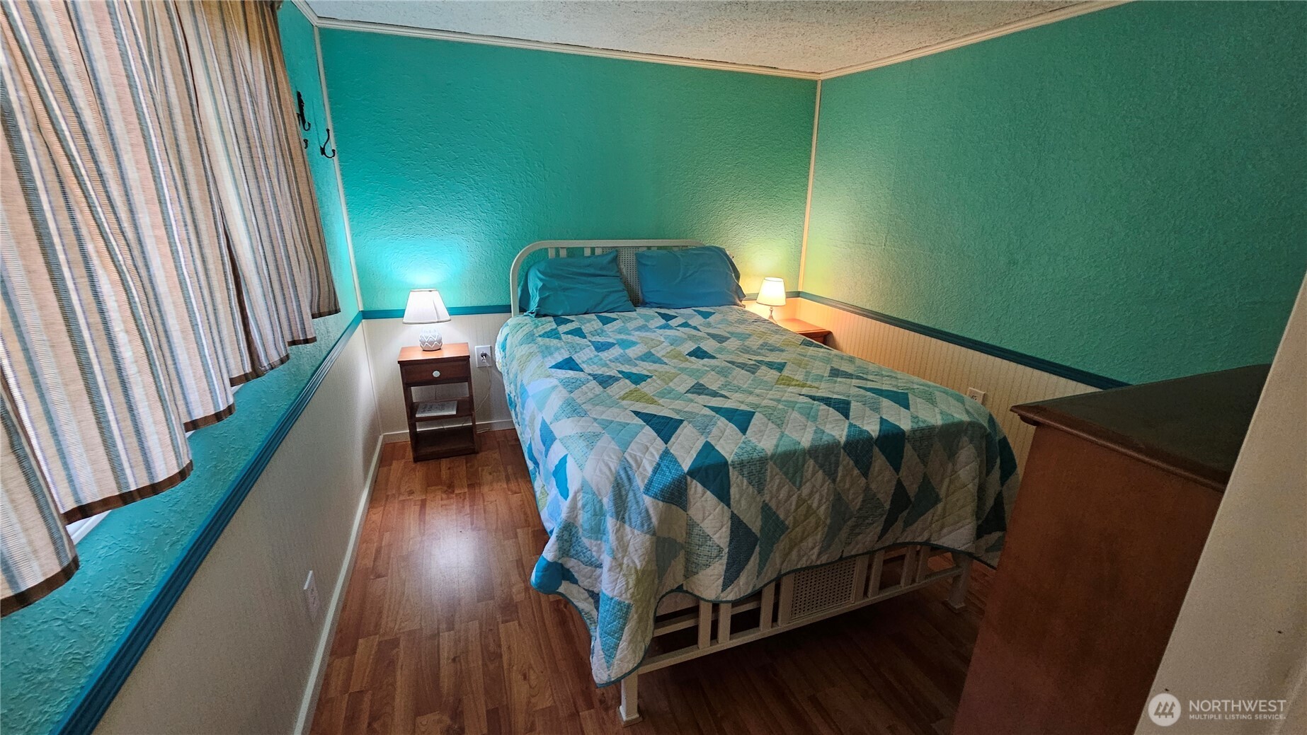 24402 P Street Ocean Park, WA 98640 - Photo 32 of 40 a bedroom with a bed next to a small yard