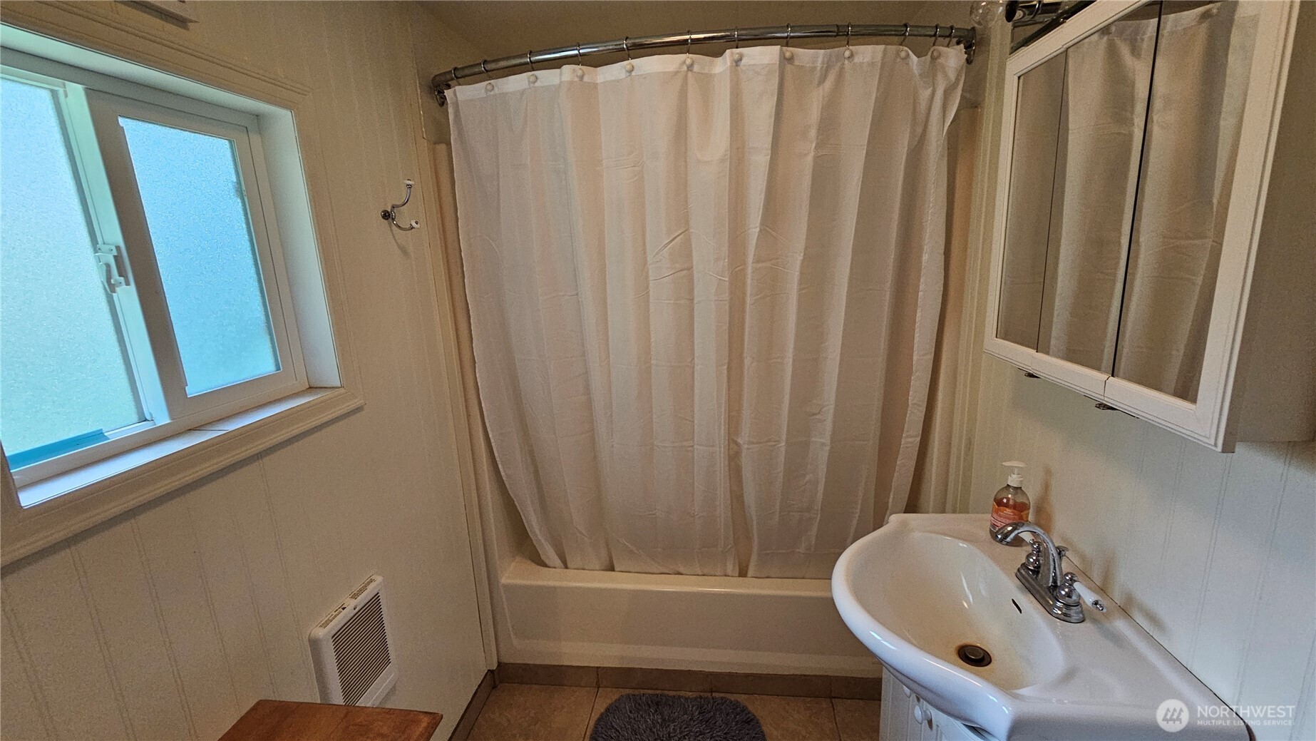 24402 P Street Ocean Park, WA 98640 - Photo 40 of 40 a bathroom with a sink a mirror and a tub