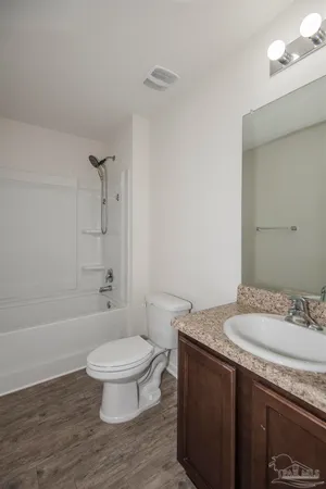 an empty room with closet and a bathroom