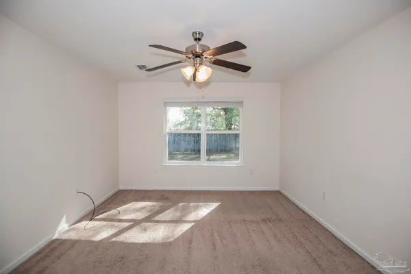 a view of a bedroom with a fan and a fan