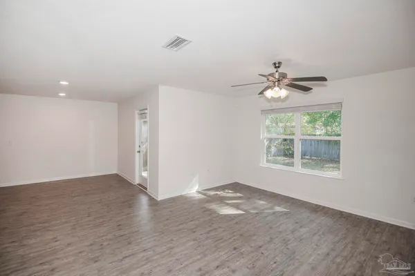 a large kitchen with stainless steel appliances a refrigerator a stove a sink a oven and a center island