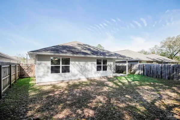 a view of a house with yard and sitting area