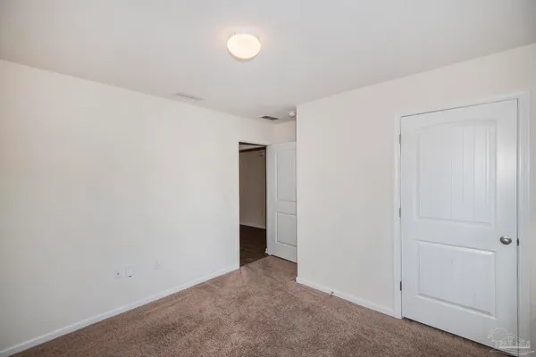 an empty room with closet area
