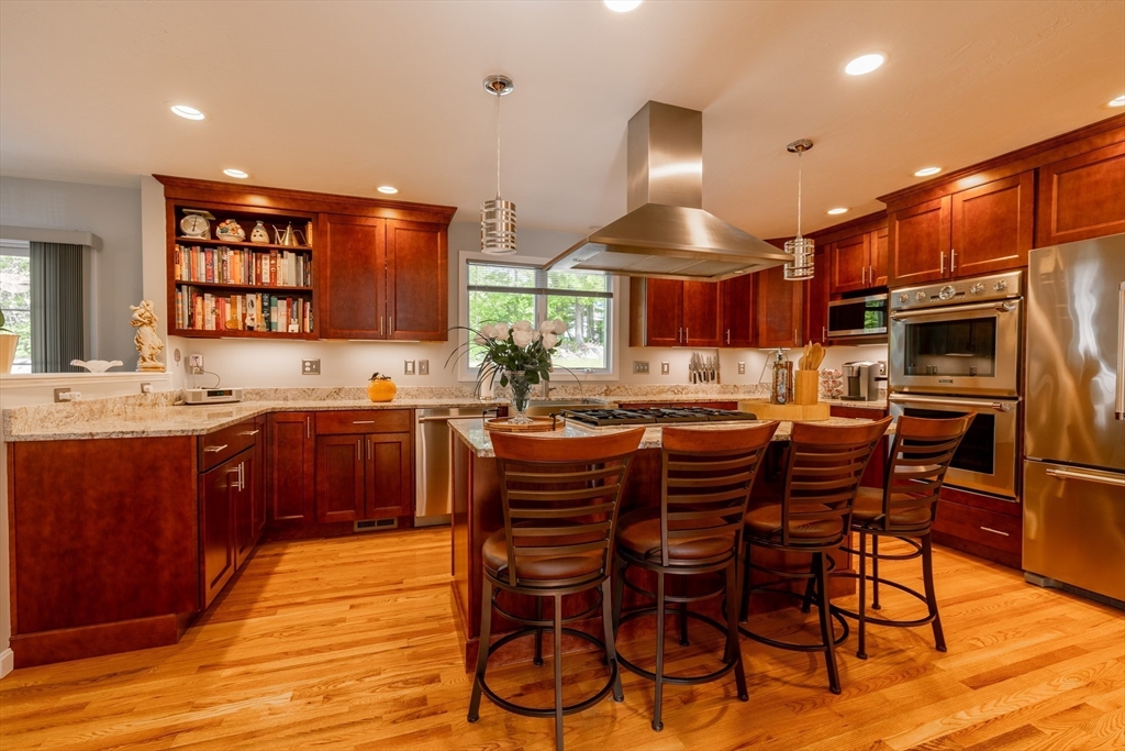 22 Duluth Street Worcester, MA 01604 - Photo 8 of 35 a kitchen with stainless steel appliances a sink a stove a refrigerator dining table and chairs