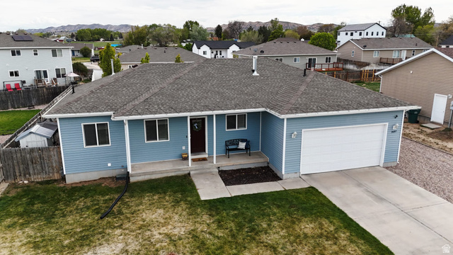 1437 925 South Vernal, UT 84078 - Photo 1 of 47 Light blue siding residence with an attached two-car garage, a dark wood front door, and a concrete driveway