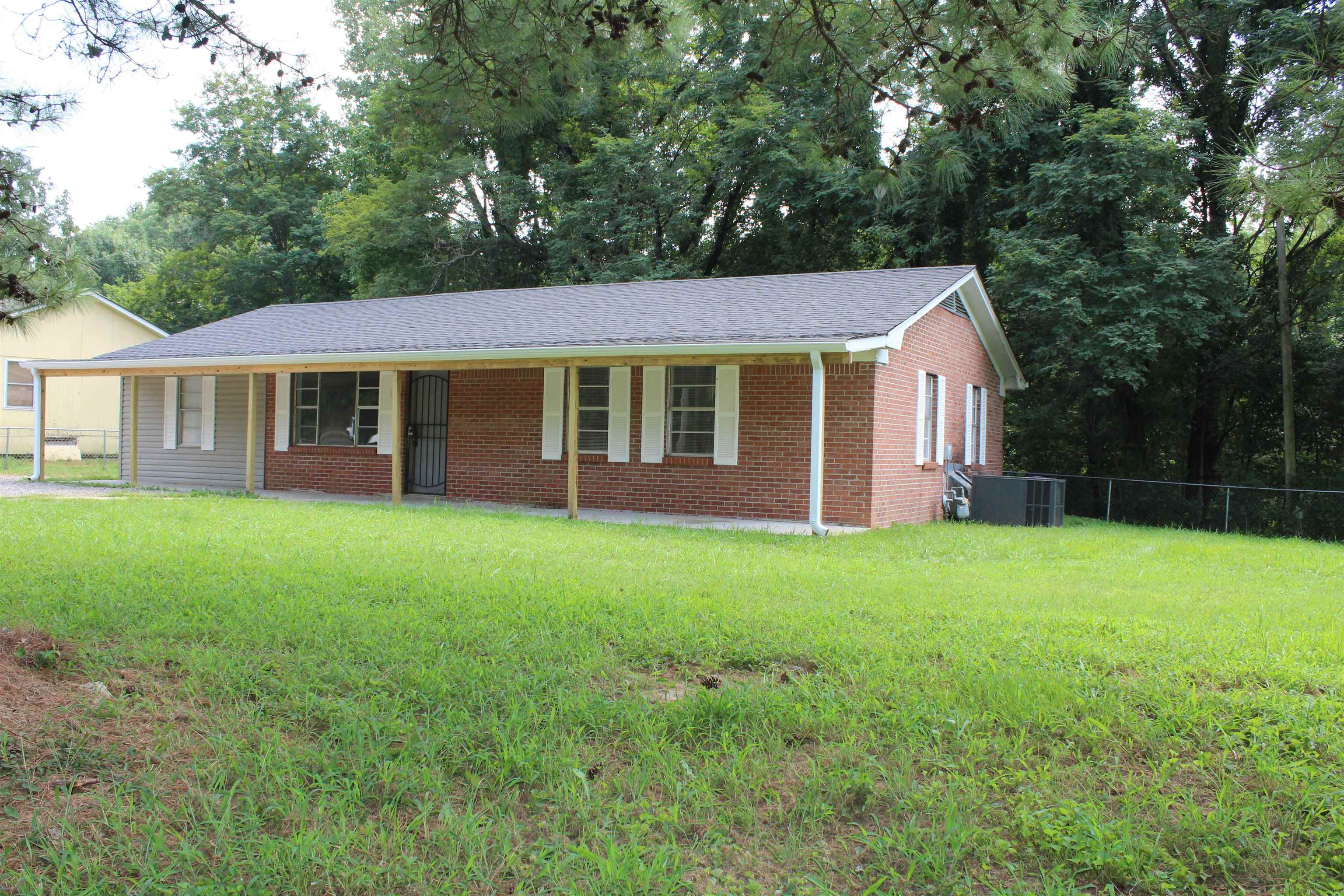 1367 Central Curve Road Ripley, TN 38063 - Photo 1 of 26 a view of a yard in front of a house with large trees