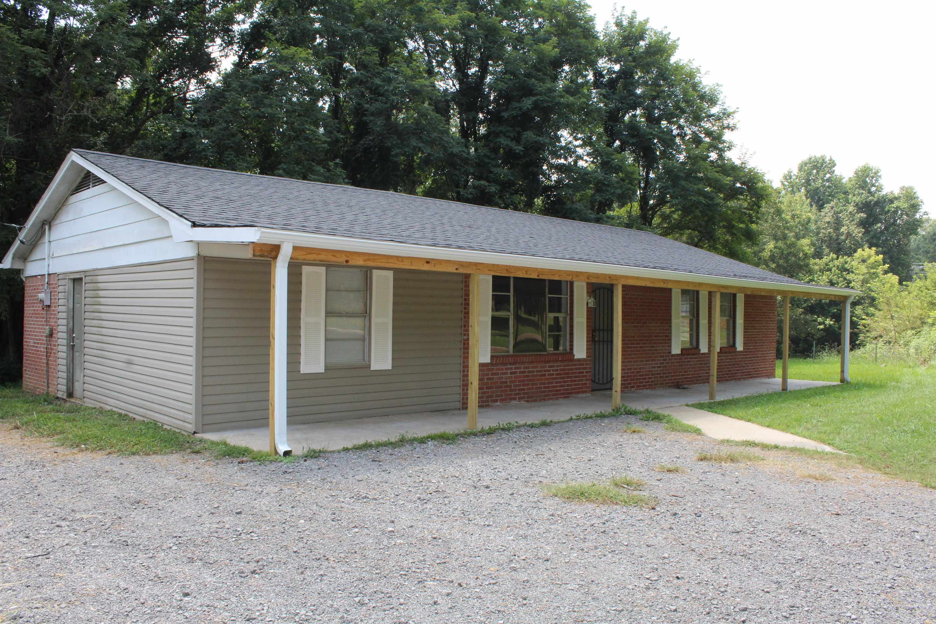 1367 Central Curve Road Ripley, TN 38063 - Photo 3 of 26 a front view of a house with a garden