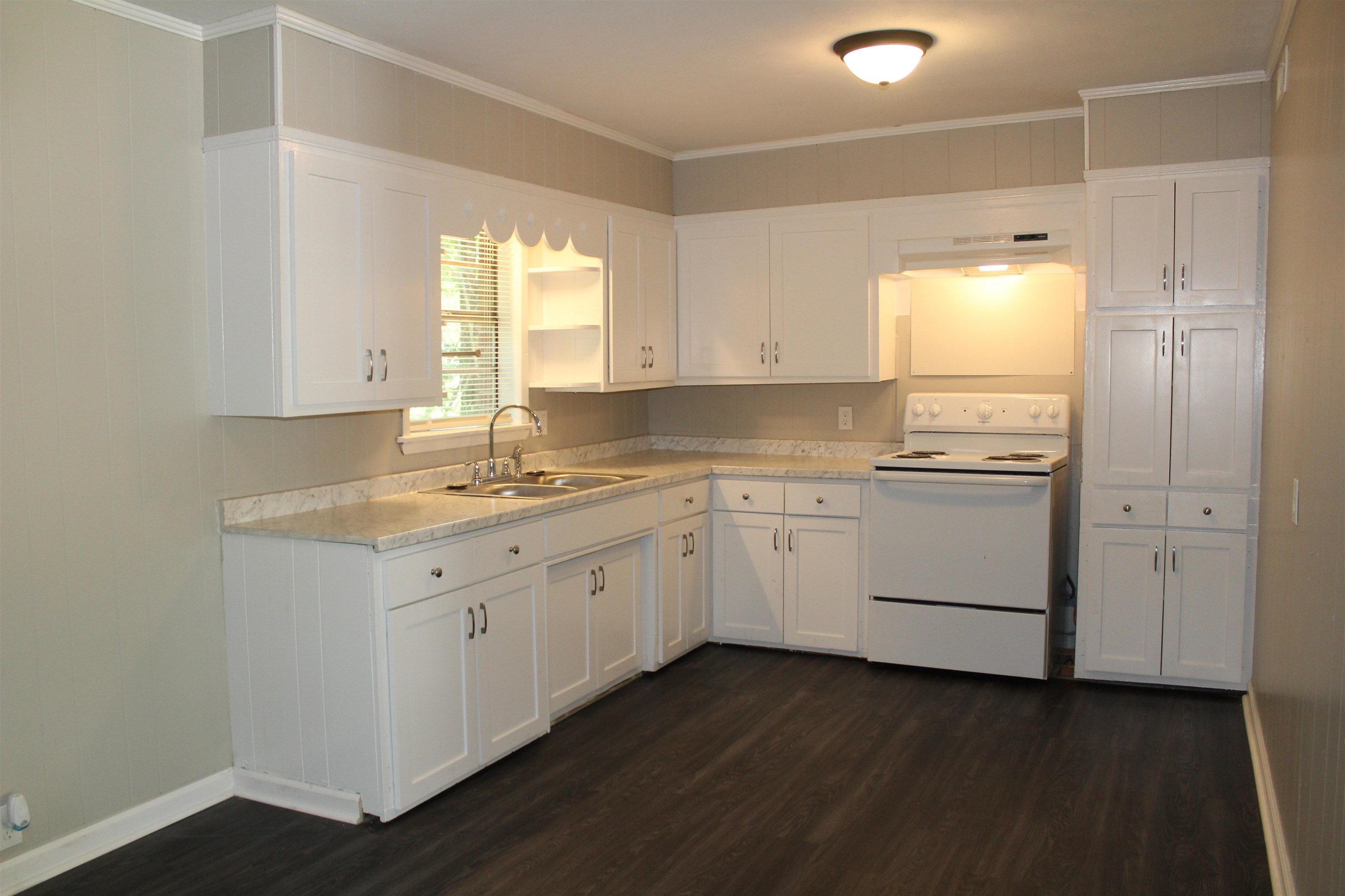 1367 Central Curve Road Ripley, TN 38063 - Photo 4 of 26 a kitchen that has a lot of white cabinets and a sink