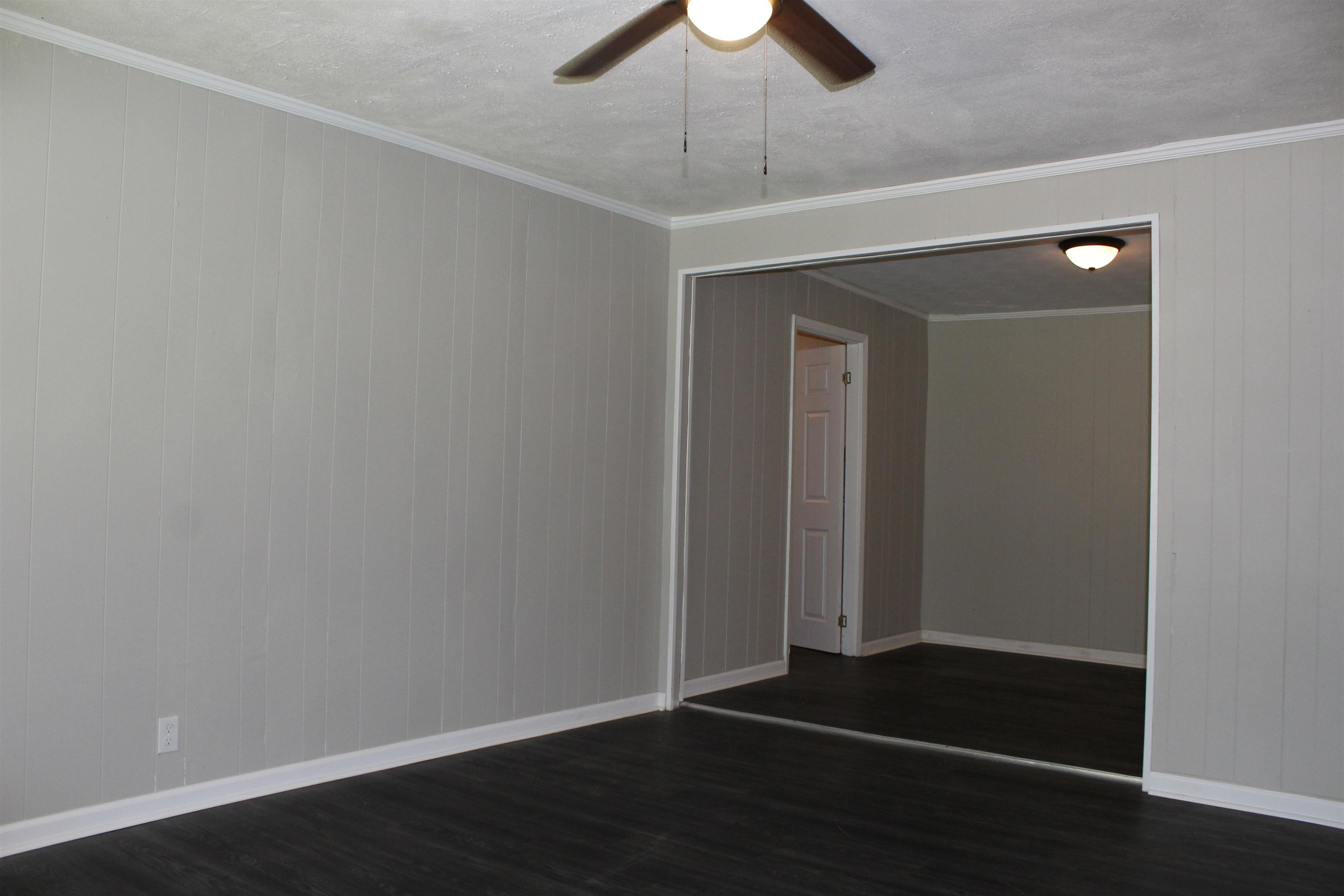 1367 Central Curve Road Ripley, TN 38063 - Photo 6 of 26 an empty room with wooden floor closet and chandelier fan