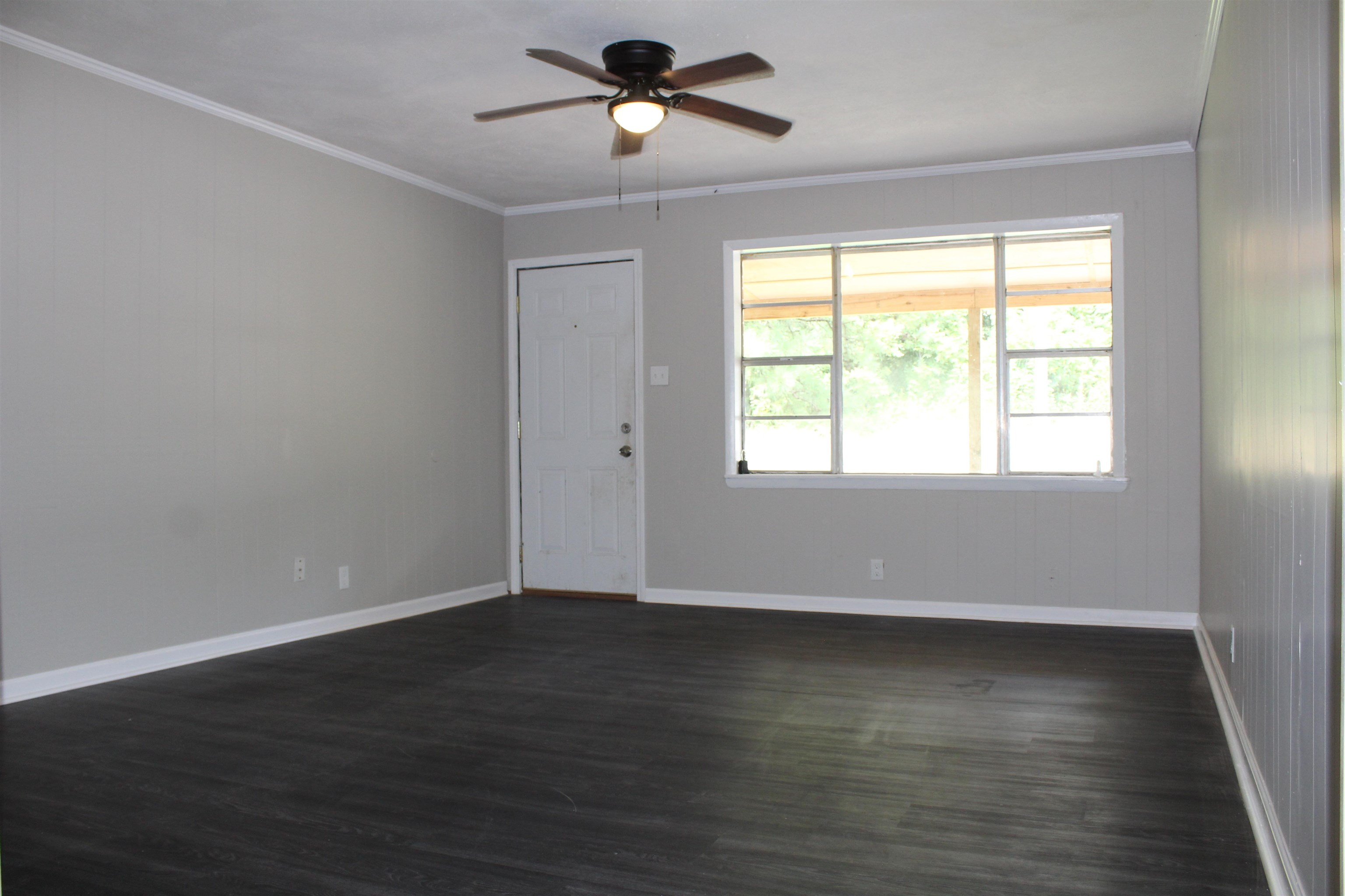1367 Central Curve Road Ripley, TN 38063 - Photo 8 of 26 a view of an empty room with wooden floor and a window
