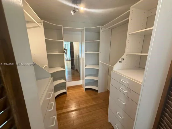 a view of walk in closet with empty racks