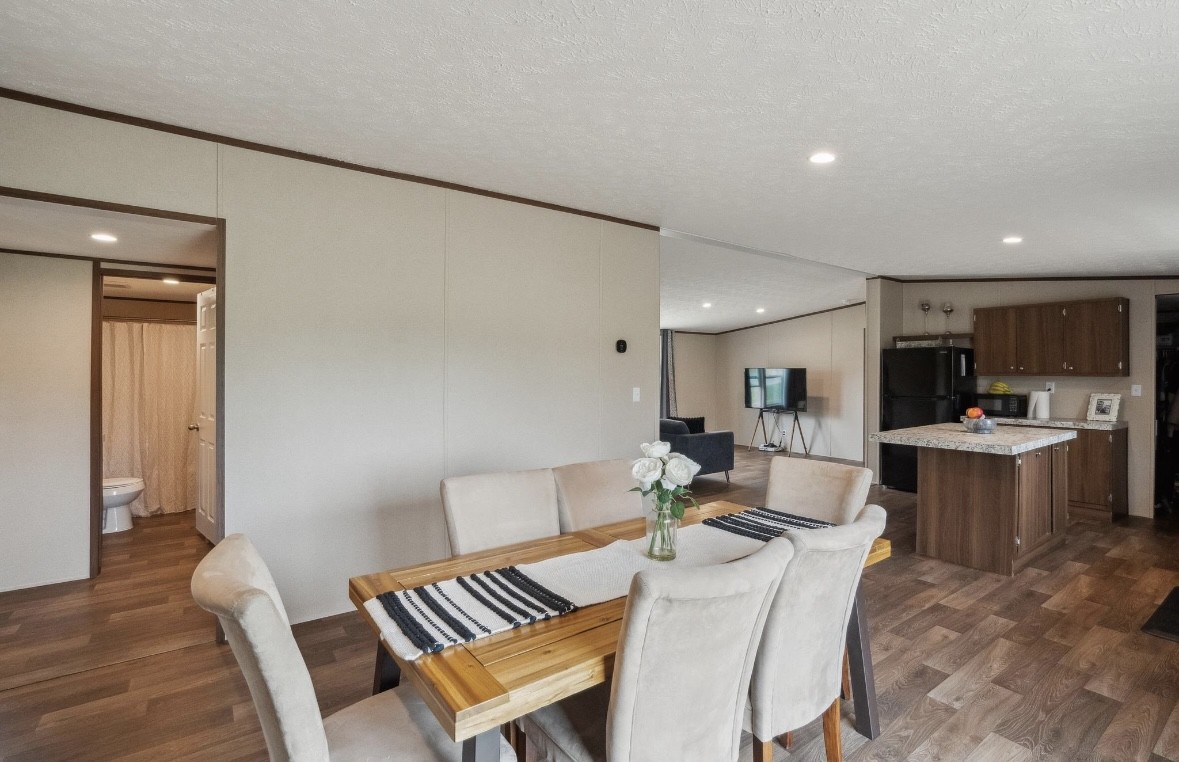 989 Ferguson Loop Dale Dale, TX 78616 - Photo 15 of 21 Dining space with vaulted ceiling, dark wood finished floors, a textured ceiling, recessed lighting, and ornamental molding
